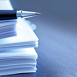 Ballpoint Pen Resting On Top Of Stack Of Documents