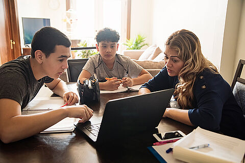 Mother homeschooling teenage boys in self-isolation, Covid-19.