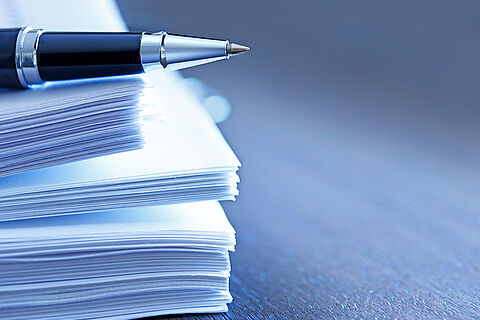 Ballpoint Pen Resting On Top Of Stack Of Documents