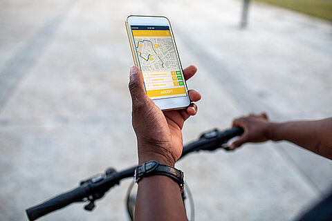 Senior African Delivery Man Checking Mobile App For Direction In the City